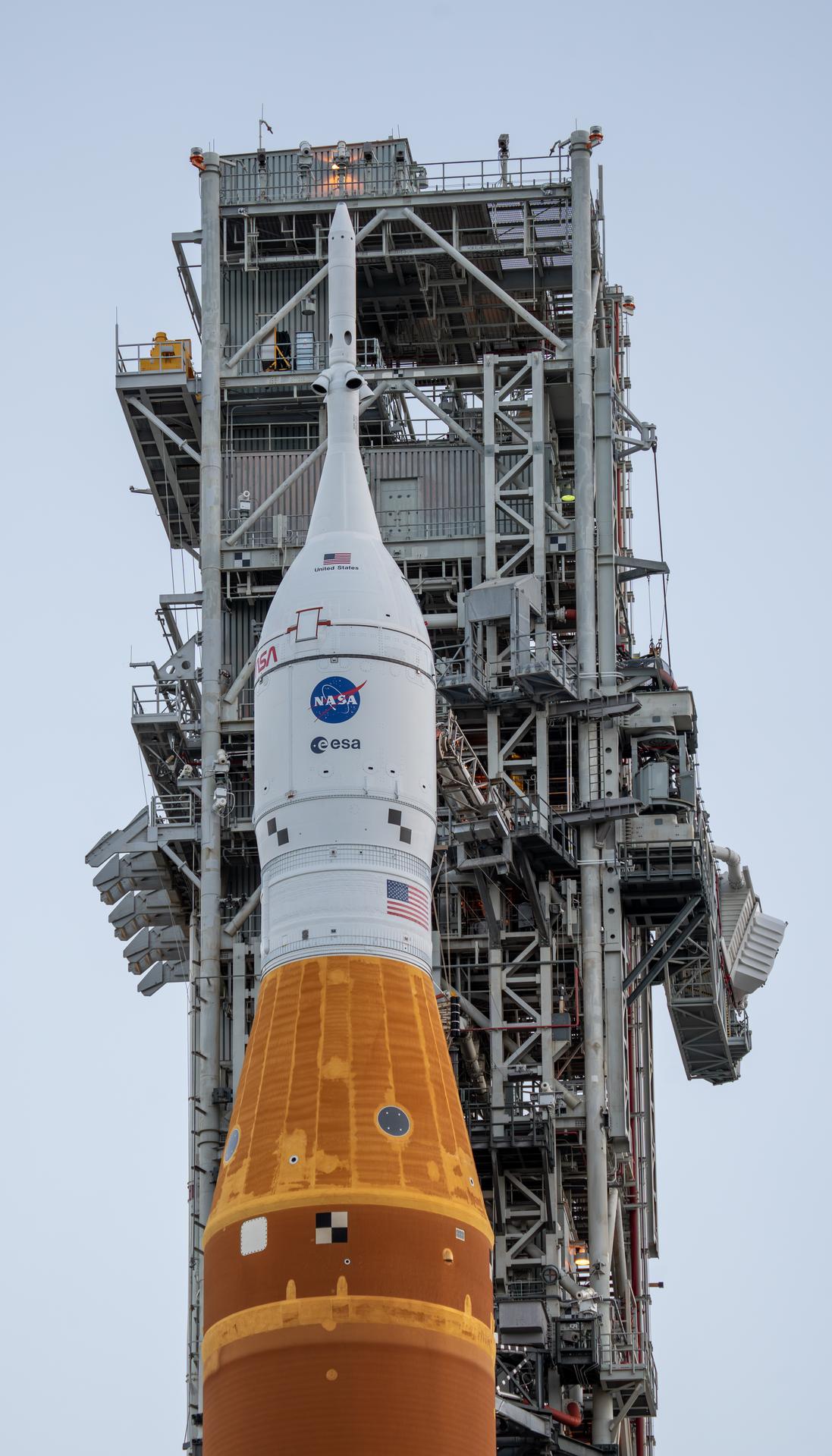 This image shows NASA’s SLS (Space Launch System) and Orion spacecraft rolling out of the Vehicle Assembly Building at NASA’s Kennedy Space Center. NASA's massive Crawler-Transporter, upgraded for the Artemis program, carries the powerful SLS rocket and Orion spacecraft on the Mobile Launcher from the Vehicle Assembly Building to Launch Pad 39B at Kennedy Space Center in preparation for the Artemis II mission. 